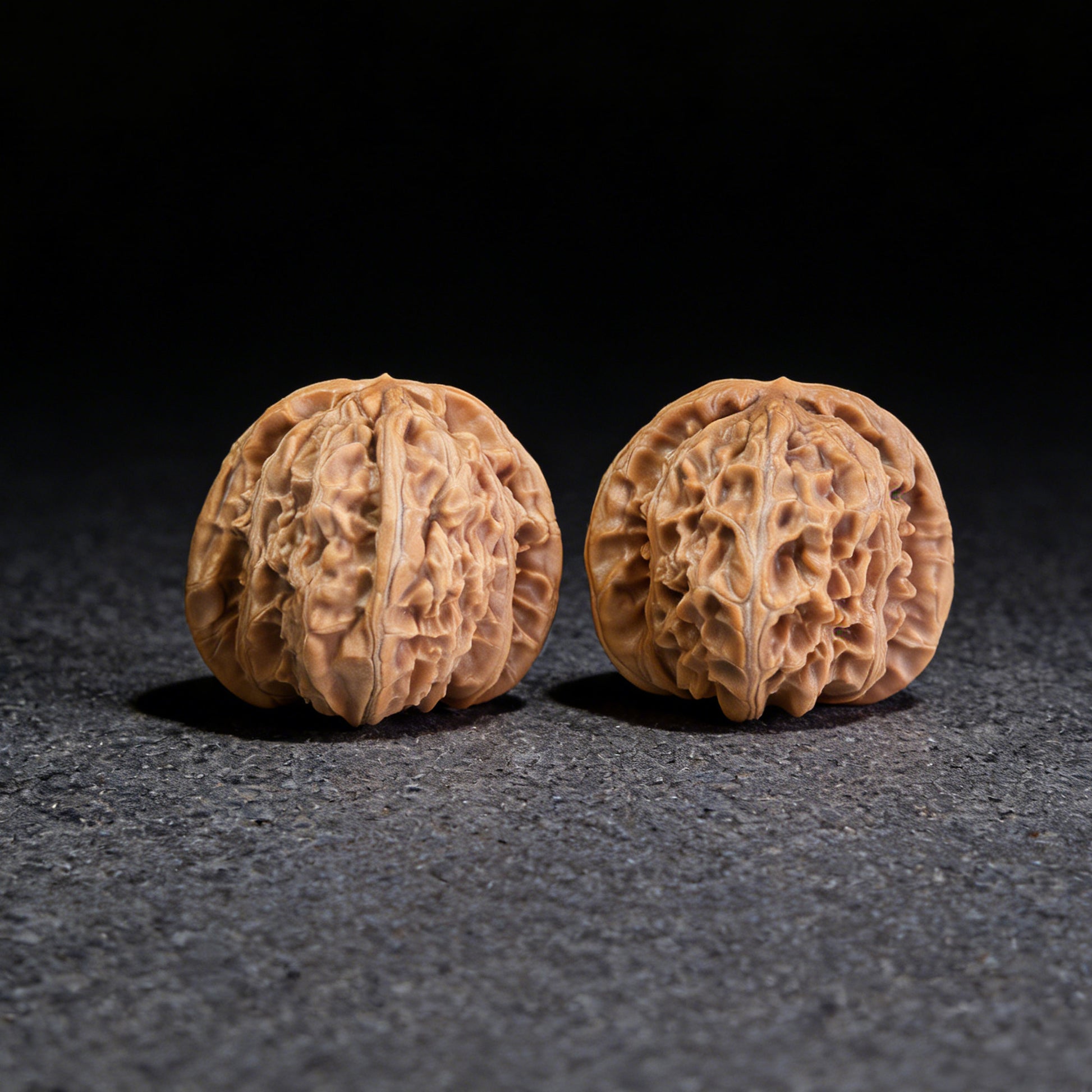 Pair of White Lion Walnut Hand Exercisers by ThePatinaProject, 40mm x 39mm, showing smooth wooden finish and ergonomic design.