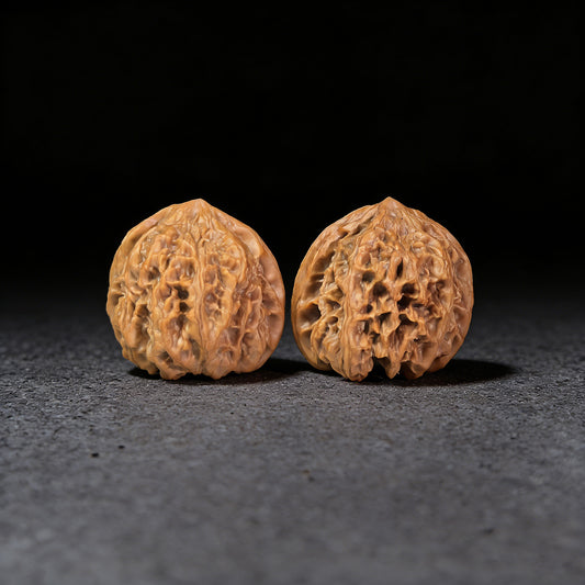 Walnut hand exercisers from ThePatinaProject, Wild Buffalo pair, 38mm x 37mm, showing textured walnut surface for grip and exercise.