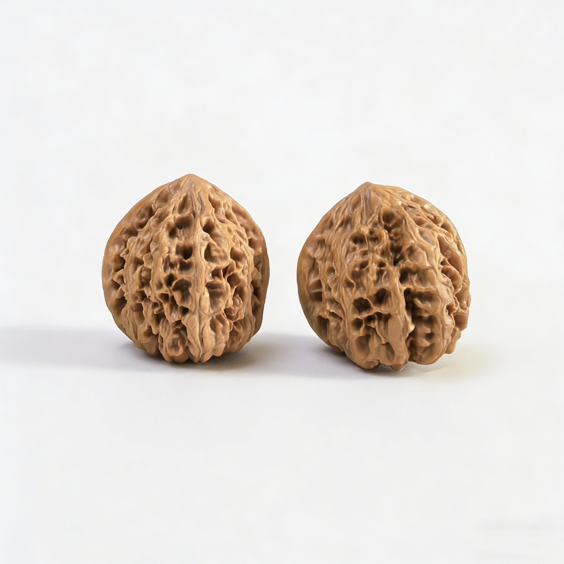 Pair of Wild Bull lion head walnut hand exercisers from ThePatinaProject, 35mm diameter, showing detailed lion head carvings.