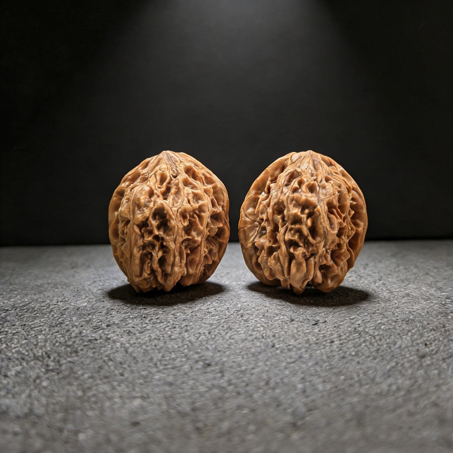 Pair of Wild Bull lion head walnut hand exercisers from ThePatinaProject, 41mm size, featuring detailed lion head design.