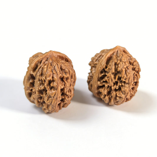 Pair of Walnut Hand Exercisers called Wild Caterpillar by ThePatinaProject, measuring 30mm x 30mm, with textured surface for grip.