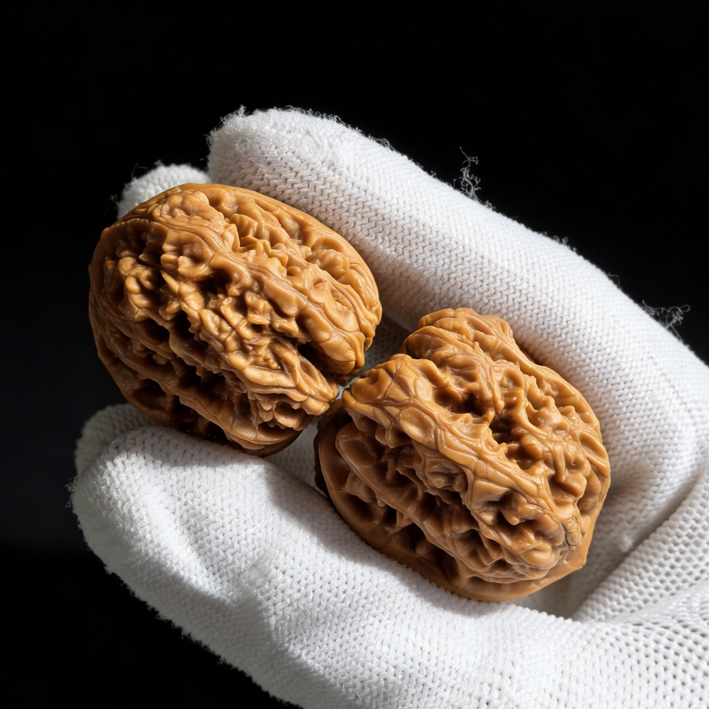 Pair of Wild Caterpillar walnut hand exercisers by ThePatinaProject, 30mm x 30mm, featuring detailed textured surface for grip and exercise.