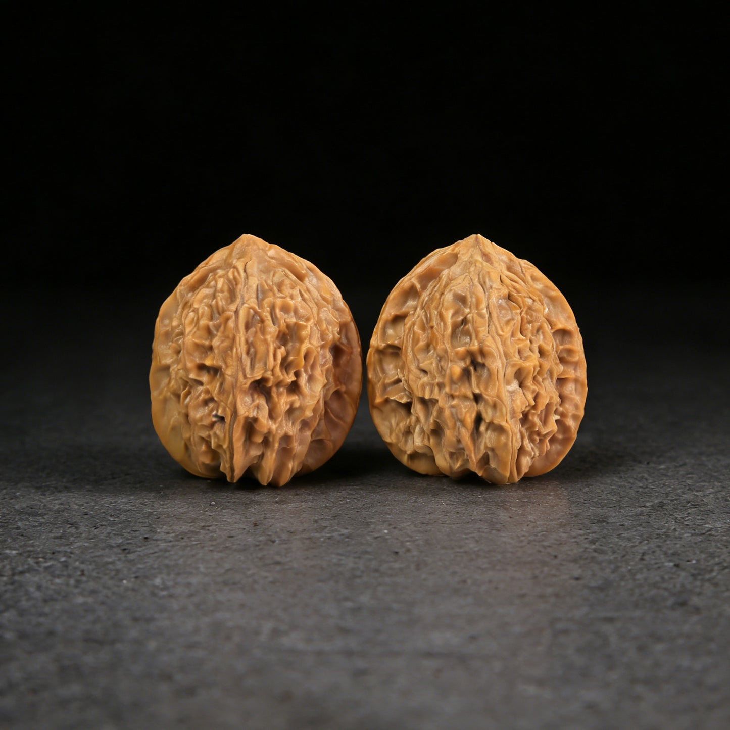 Walnut hand exerciser pair "Wild Mountain" by ThePatinaProject, 31mm size, textured wooden grip, ergonomic design for hand strength.