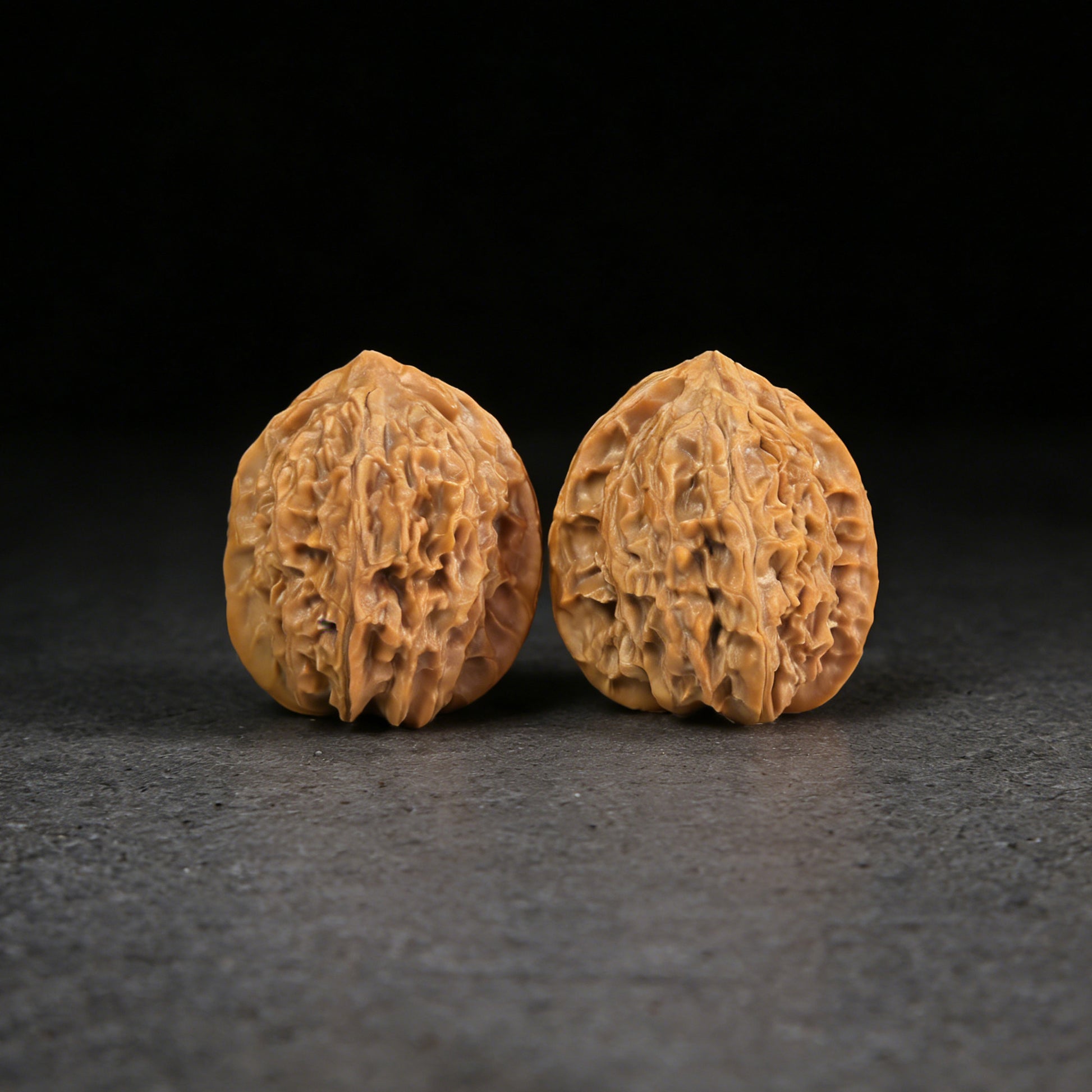 Walnut hand exerciser pair "Wild Mountain" by ThePatinaProject, 31mm size, textured wooden grip, ergonomic design for hand strength.