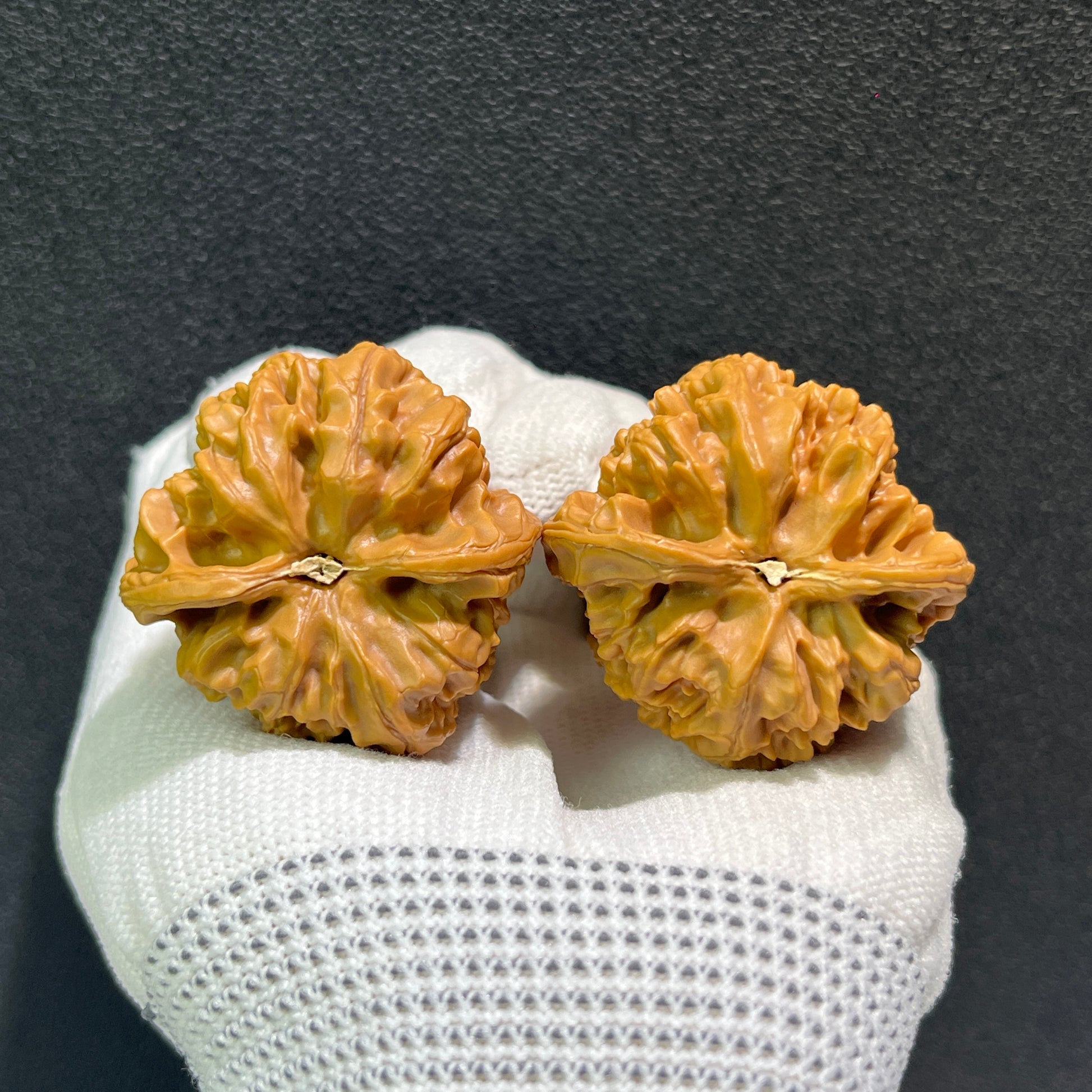 Walnut hand exerciser pair by ThePatinaProject, Wild Ox (Ye Niu), 39mm x 38mm, YN-402, showing textured walnut grips.