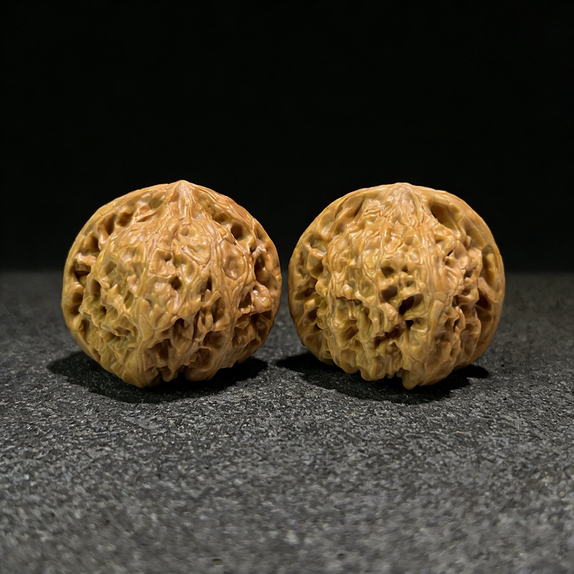 Pair of Wild Ox Walnut Hand Exercisers, 40mm x 38mm, YN-401 by ThePatinaProject, showing textured walnut grips for hand strength training.