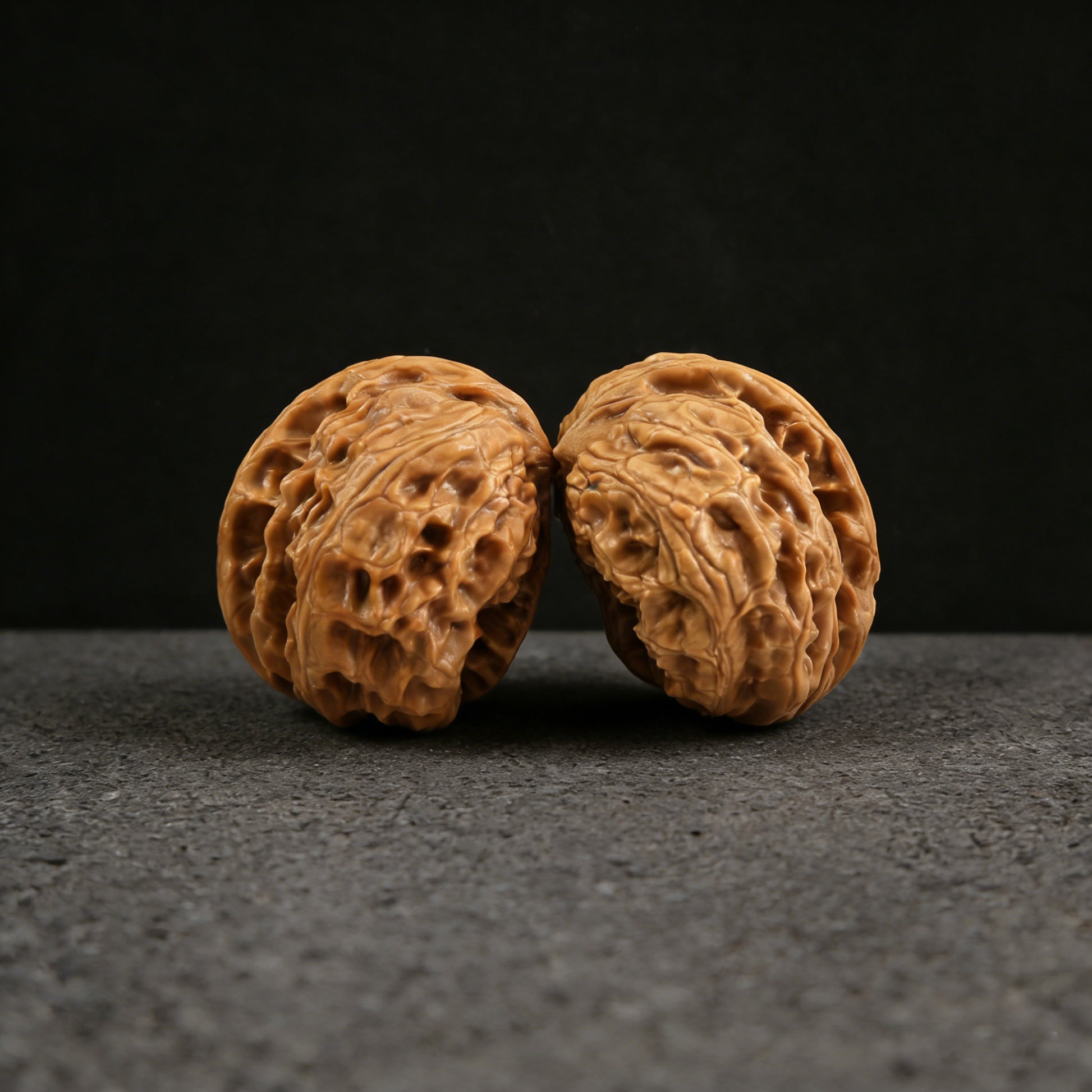 Pair of Wild Wolf Half-Wall Walnut Hand Exercisers by ThePatinaProject, 39mm BBYL-01, showing textured walnut wood grips.