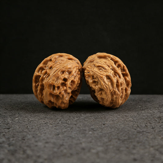 Pair of Wild Wolf Half-Wall Walnut Hand Exercisers by ThePatinaProject, 39mm BBYL-01, showing textured walnut wood grips.