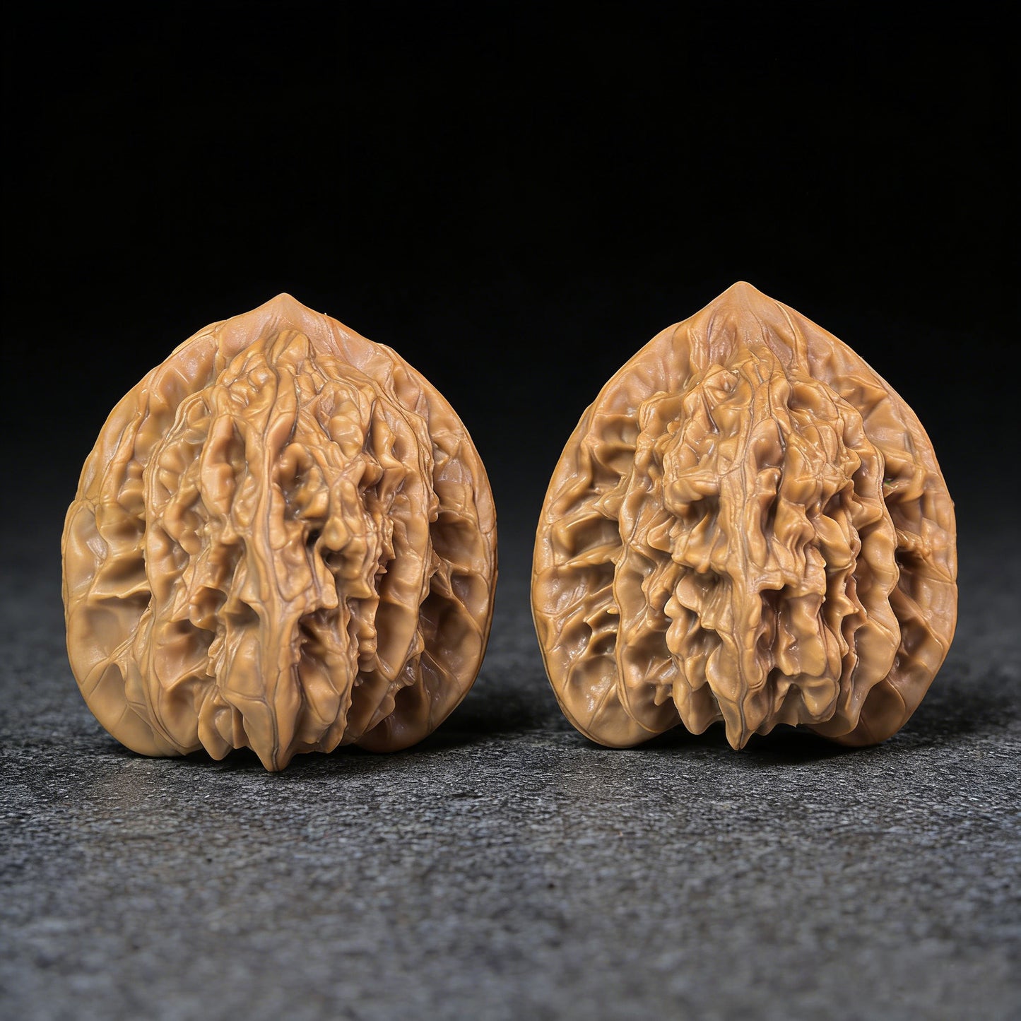 Pair of Xia Yun Ling walnut hand exercisers from ThePatinaProject, featuring lion head designs, measuring 40mm x 37mm.