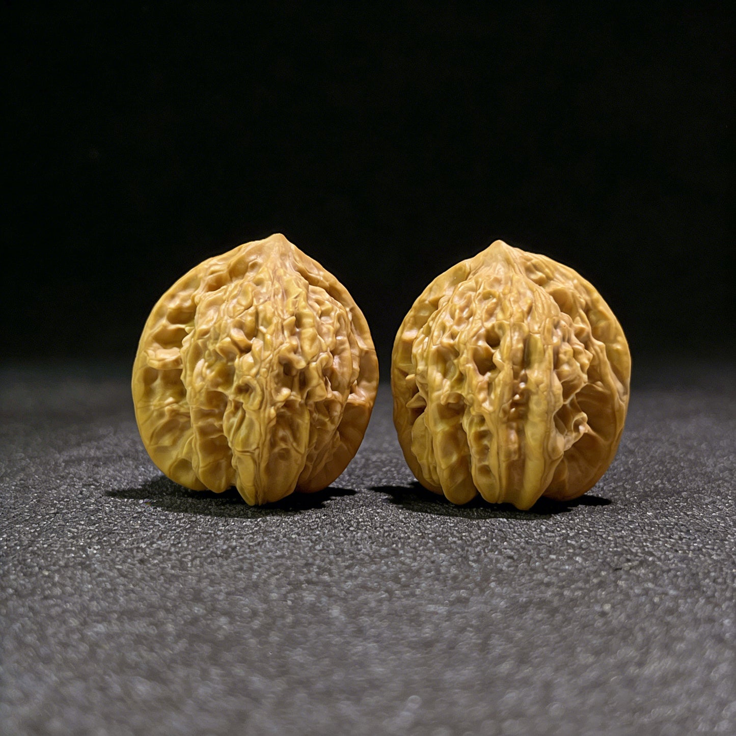 Walnut hand exerciser from ThePatinaProject, model XYL-602, measuring 35.0mm by 33.0mm, with textured walnut surface for grip