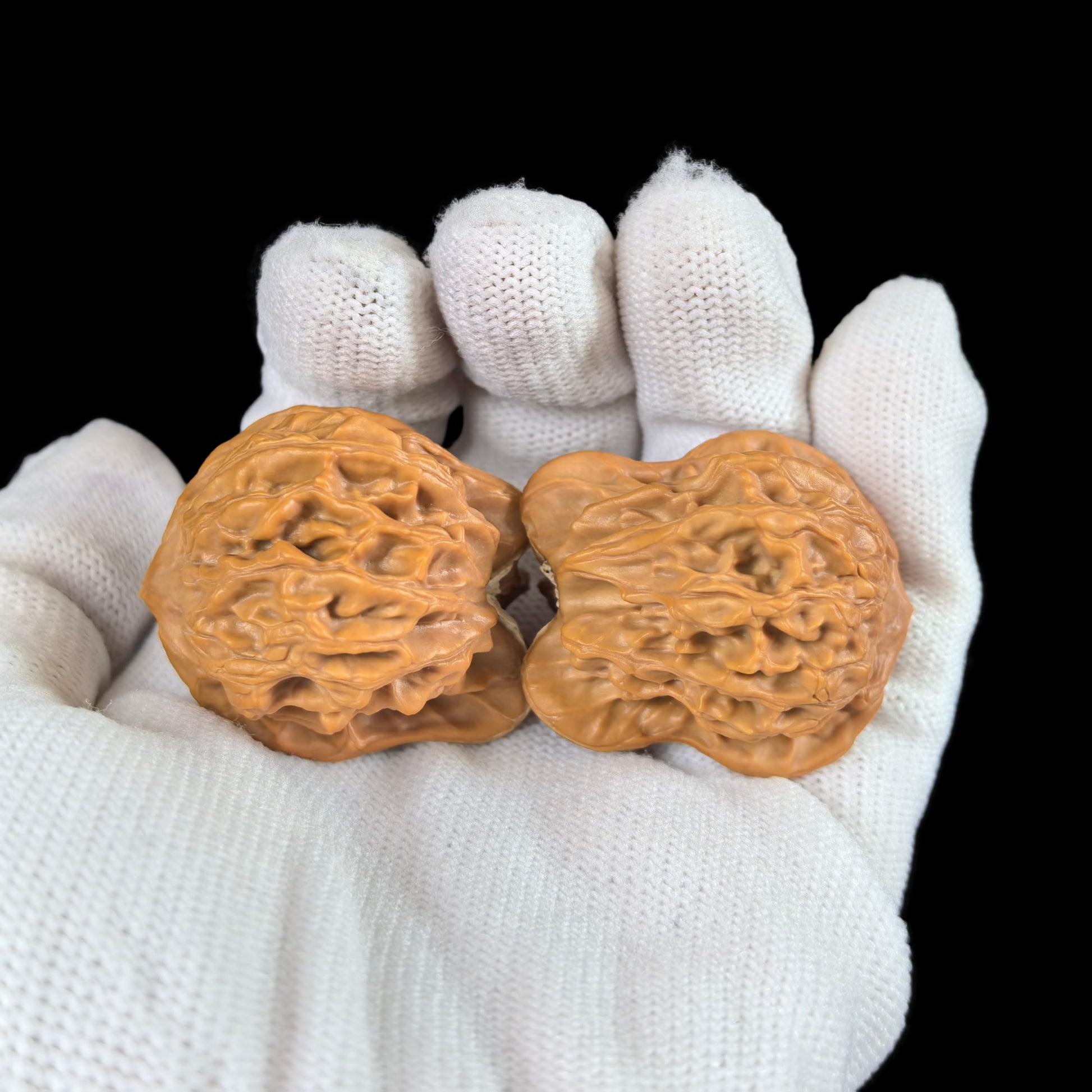 Pair of Xiao Niao walnut hand exercisers from ThePatinaProject, 32mm size, showing textured walnut wood handles for grip and exercise.