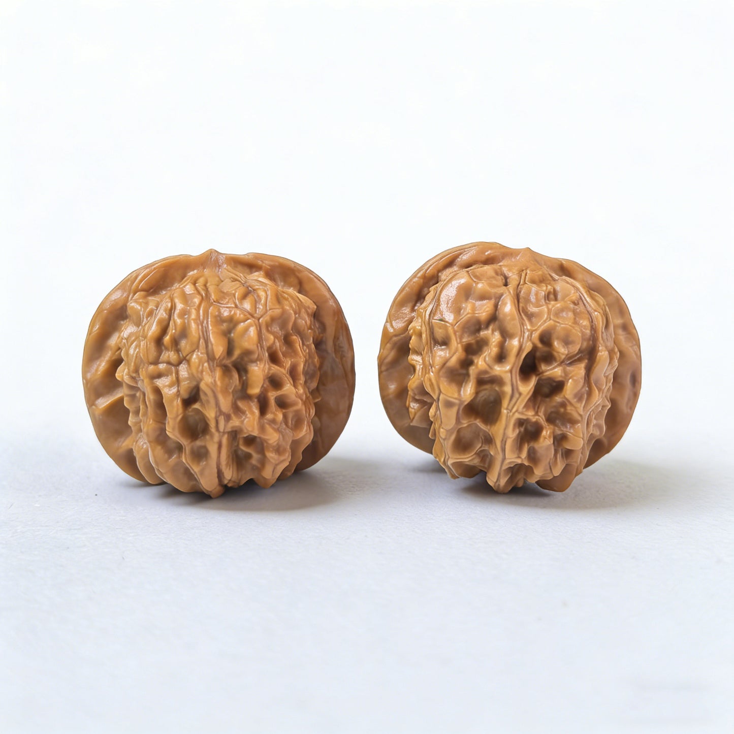Pair of Xinglong Shaozi walnut hand exercisers, 35mm, from ThePatinaProject, showing textured wooden surfaces for grip and hand strengthening.