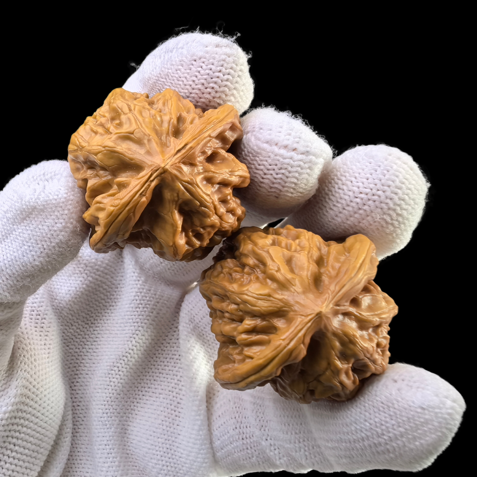Walnut hand exercisers, ThePatinaProject Ye Niu Wild Buffalo Pair, 35mm YN-01, showing textured walnut grips for grip strength training.
